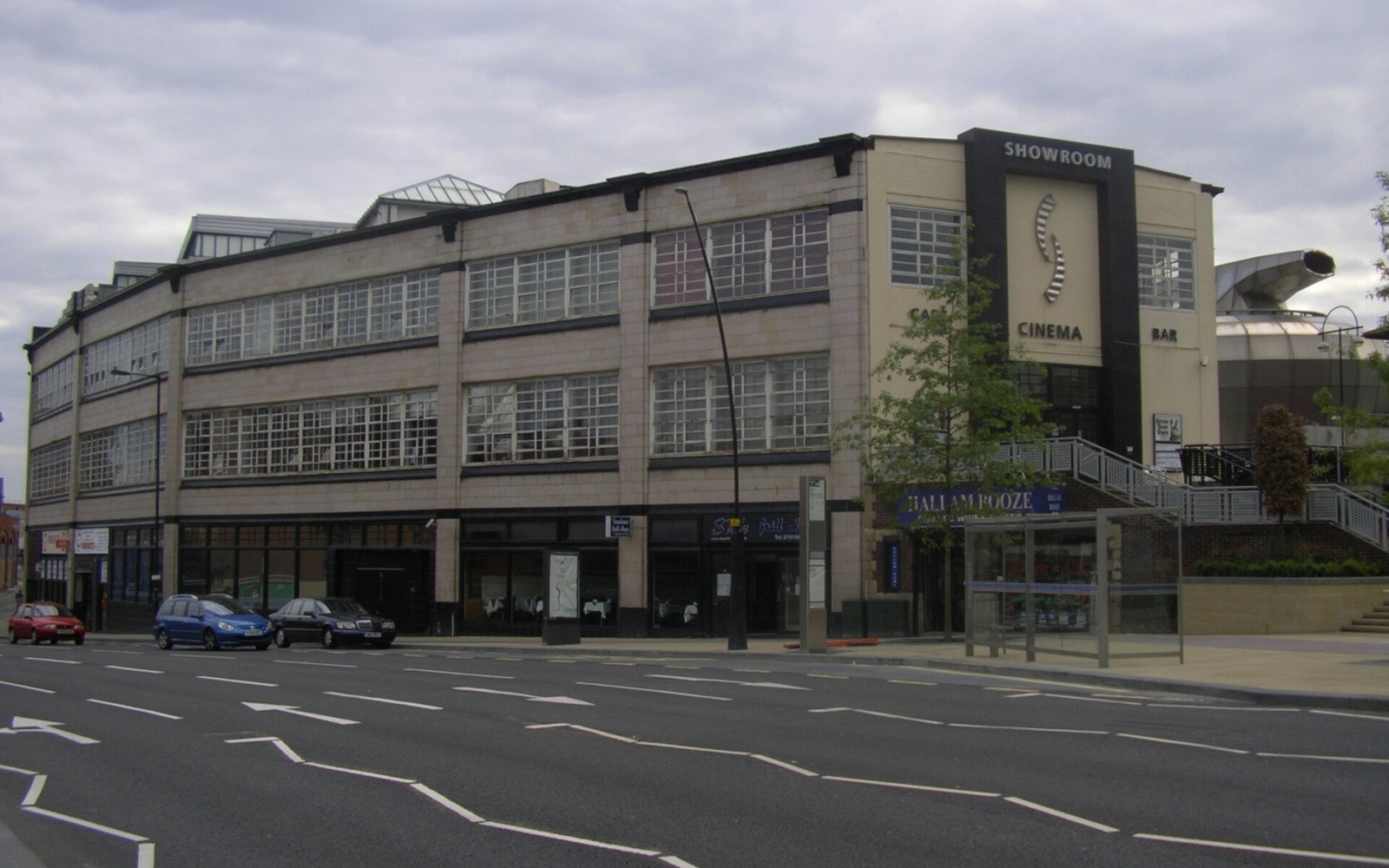 Corner building with Showroom cinema signage overlooking an empty street intersection