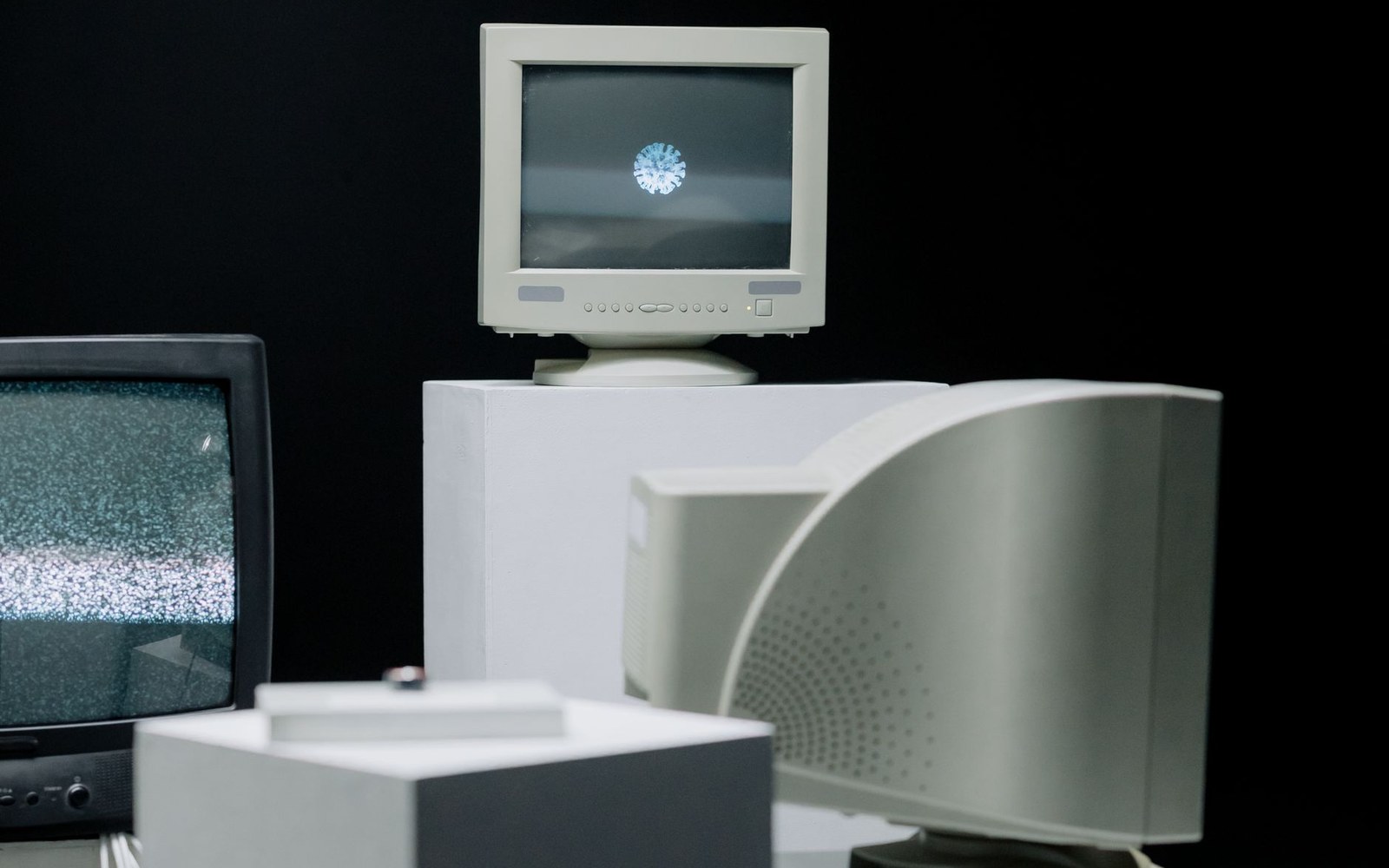 CRT monitors in a darkened studio, one carrying a test image